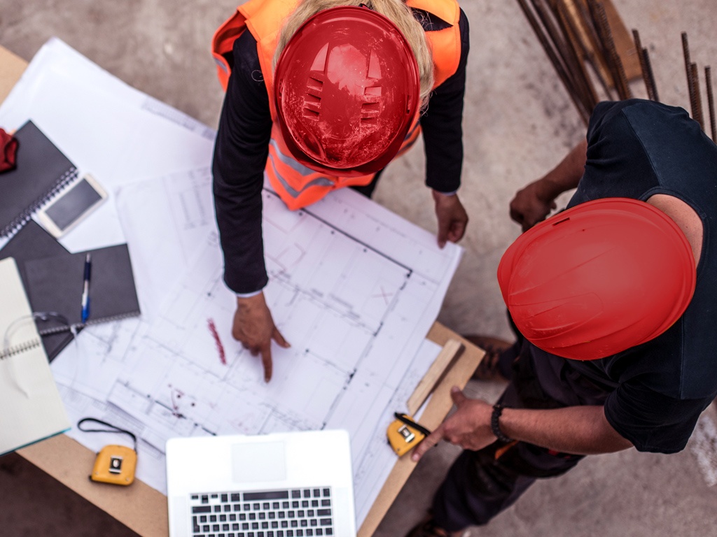 Construction workers with blueprints